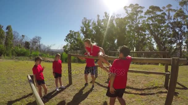 Trainerin Unterstützt Ein Schulmädchen Bei Einem Hindernisparcours Einem Sonnigen Tag — Stockvideo