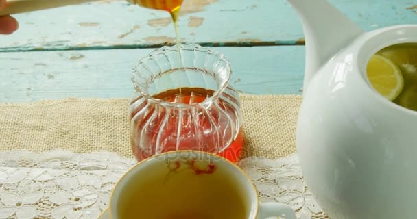 Close Hand Pouring Honey Herbal Tea — Stock Video