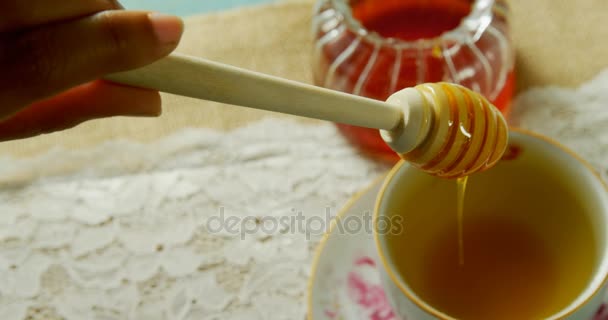 Close Hand Pouring Honey Herbal Tea — Stock Video