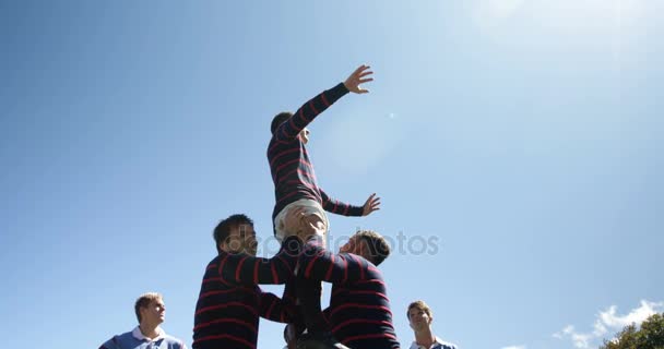 Rugby players practicing to defend the ball on a sunny day 4K — Stock Footage Rugby Players Practicing Defend Ball Sunny Day Stock Footage