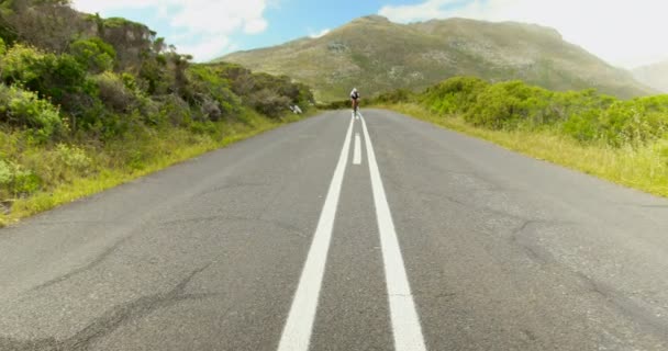 Female Cyclist Cycling Countryside Road Sunny Day — Stock Video