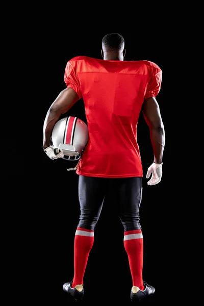 Zadní Pohled Afroamerického Fotbalistu Uniformě Polštářky Rukavicemi Helmou Podpaží — Stock fotografie