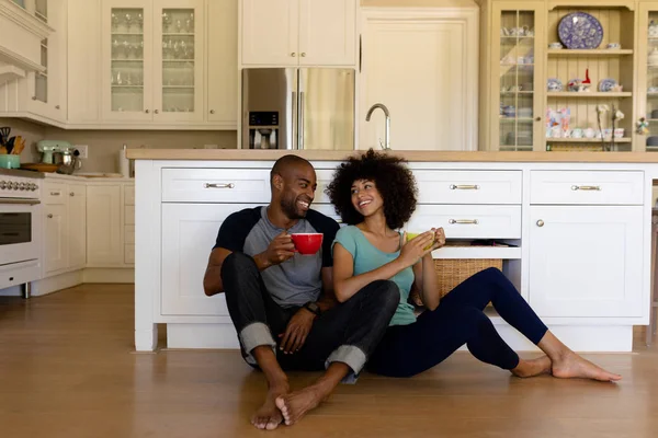 Frontansicht Eines Gemischten Rassenpaares Das Auf Dem Boden Der Küche — Stockfoto