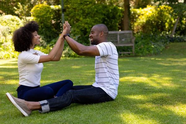 Side View Mixed Race Couple Sitting Grass Garden Holding Hands — Stock Photo, Image