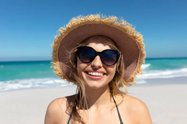 背景に青い空と海のある藁帽子をかぶった白人女性の肖像画が カメラに微笑んだ — ストック写真