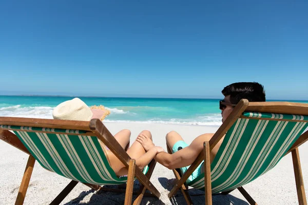 Rear View Caucasian Couple Sitting Deckchairs Beach Blue Sky Sea — Stock Photo, Image