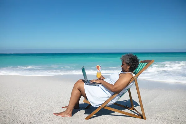 Vista Lateral Una Mujer Afroamericana Mayor Una Playa Sol Sentada — Foto de Stock