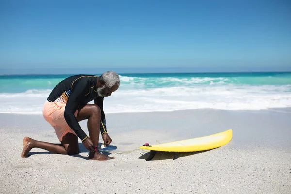 Side View Senior African American Man Beach Sun Kneeling Attaching — 스톡 사진
