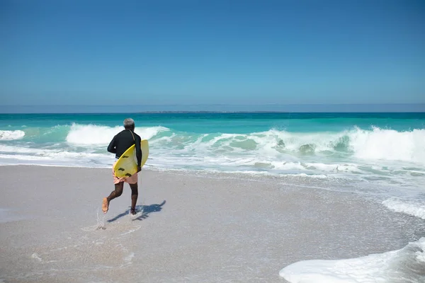 Rear View Senior African American Man Beach Sun Carrying Surfboard — 스톡 사진