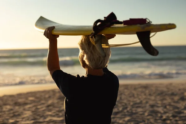 Rear View Senior Caucasian Woman Beach Sunset Holding Surfboard Her — 스톡 사진