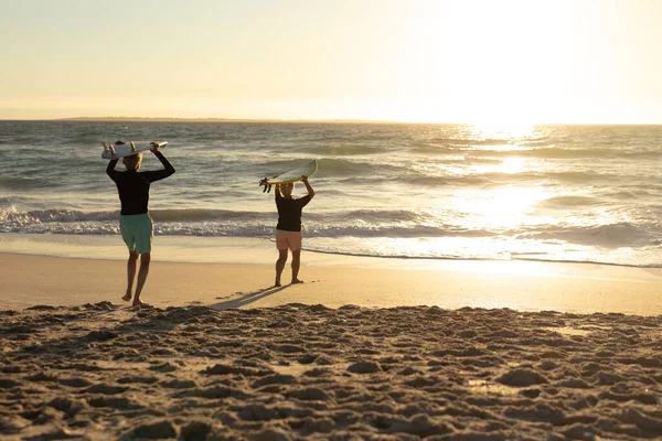 Rear View Senior Caucasian Couple Beach Sunset Holding Surfboards Heads — Stock Photo, Image