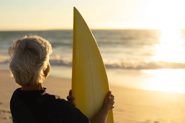 Rear View Senior Caucasian Woman Beach Sunset Standing Sand Holding — 스톡 사진