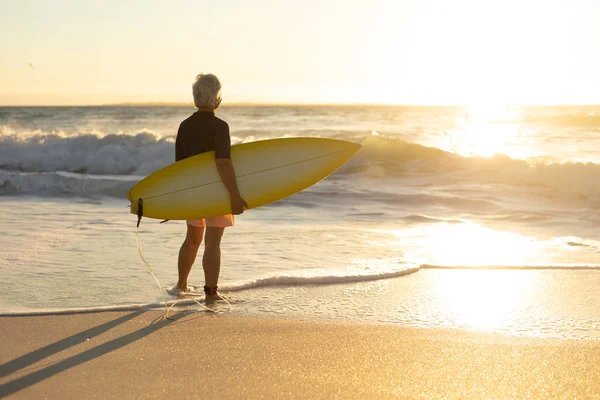 Rear View Senior Caucasian Woman Beach Sunset Standing Sand Holding — 스톡 사진