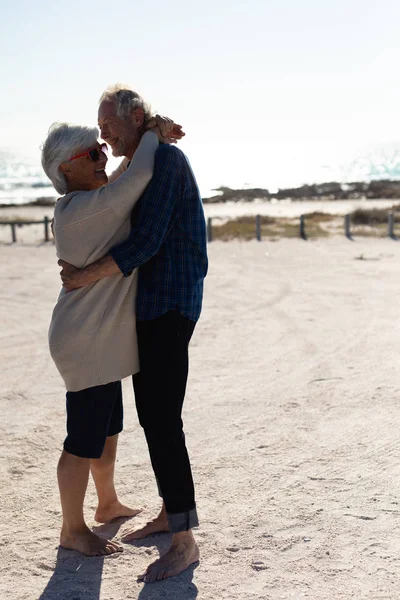 Side View Senior Caucasian Couple Sitting Beach Sun Embracing Smiling — 스톡 사진