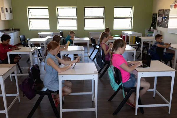 Side View Diverse Group Schoolchildren Concentrated Sitting Desks Using Personal — Stok fotoğraf