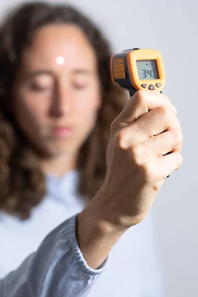 Caucasian Woman Long Curly Hair Examining Her Temperature Holding Non — Stock Photo, Image