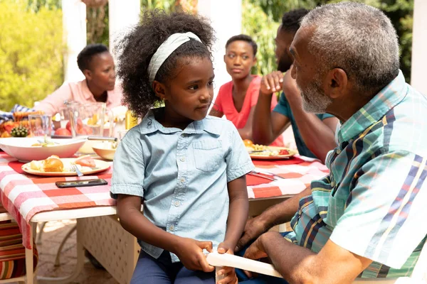 African American Girl Sitting Her Grandfather Knees Family Lunch Garden — Stock Photo, Image