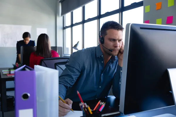 Vista Frontal Hombre Caucásico Con Auriculares Trabajando Una Oficina Moderna —  Fotos de Stock