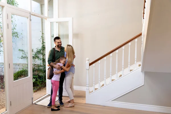 Side View Caucasian Couple Daughter Embracing Hallway House Front Door — Stock Photo, Image