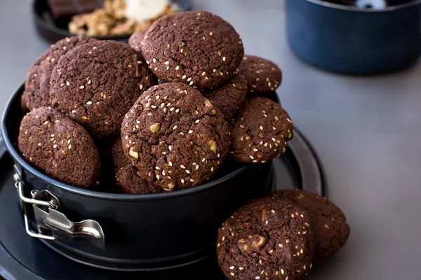 On the metal form, chocolate biscuits with sesame