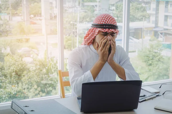 stressed young Arabian business man feel sad worry tired frustrated upset fail after working finance about cost with laptop computer, document on desk at office, emotion, business, investment concept
