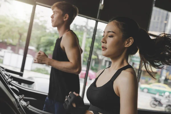 Running. asian young people beautiful woman slim body jogging run cardio training on treadmill machine in fitness gym for good health at morning, bodybuilder, exercise fitness, workout sport concept