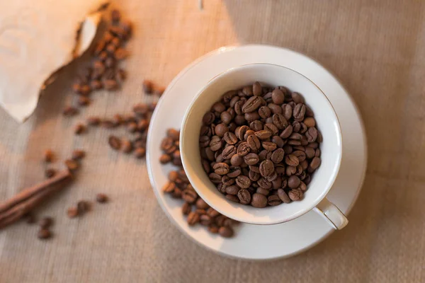 coffee beans from natural packaging are scattered on a hundred. Coffee Mug