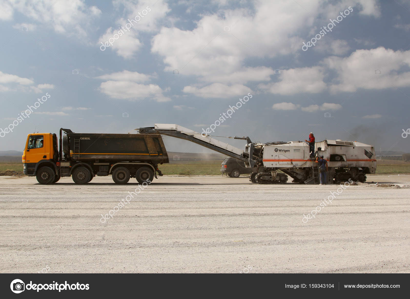 Cold milling machine removing asphalt layer on a runway ...
