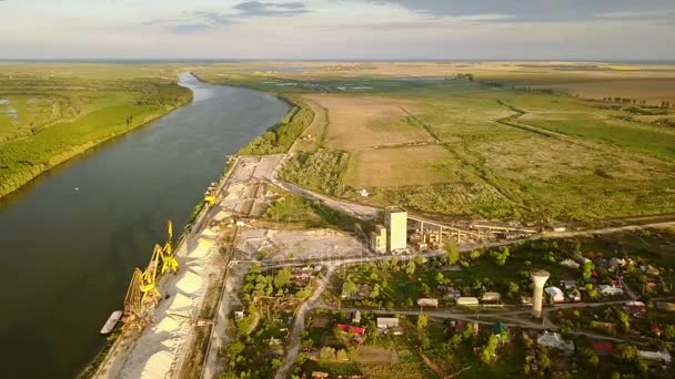 Industrial cargo port with cranes on the Danube river, aerial view — Stock Video