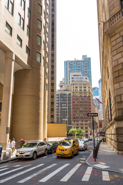 New York, NYC, USA August 26, 2017 Streets and skyscrapers in the center of new York city near Wall Street, historical financial center NY on a hot summer day in Manhattan.