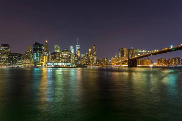 View on skyscrapers in lower Manhattan from Brooklyn skyline in New York City at night. Royalty Free Stock Images