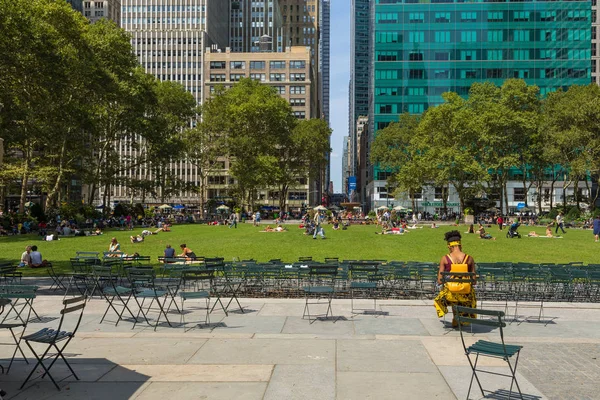 İnsanlar yaz, güneşli günde Bryant Park'ta rahatlatıcı.