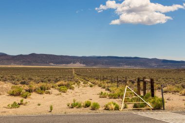Gravel road surrounded by a wooden fence, California, USA.