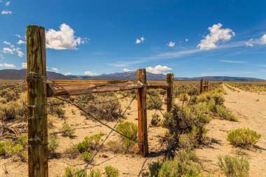 Gravel road surrounded by a wooden fence, California, USA.