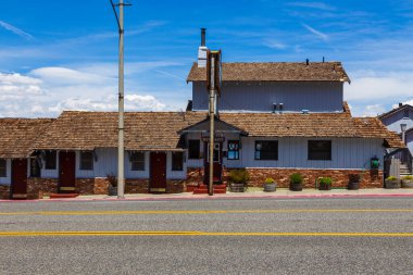 Lee Vining, California, USA- 03 June 2015: View of the Yosemite Gateway Motel in the center of town. A building made of blue boards covered with tiles.