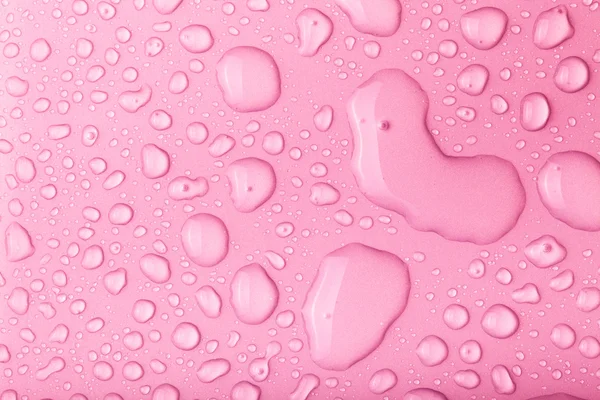 Druppels water op een gekleurde achtergrond. Roze. Toned — Stockfoto