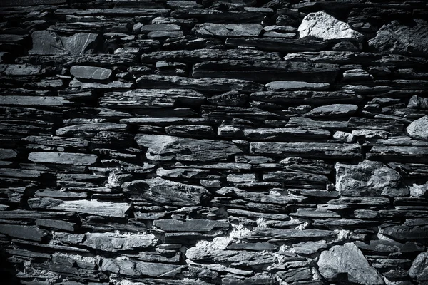 Detail of a wall of an ancient stone house. Toned — Stock Photo, Image