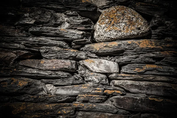 Detail of a wall of an ancient stone house. Toned — Stock Photo, Image