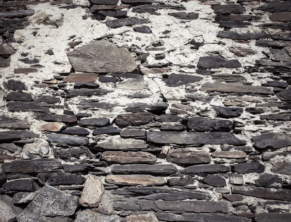 Detaljer om en mur av et gammelt steinhus. Garvet – stockfoto