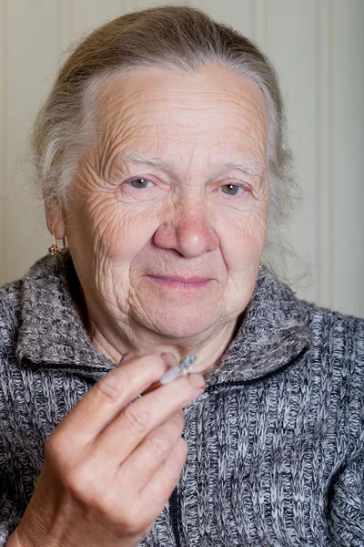 Porträt einer älteren Frau auf hellem Hintergrund — Stockfoto