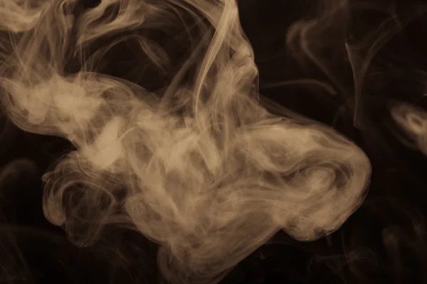 Nuvola di fumo su sfondo nero. Concentrazione selettiva. Tonica — Foto Stock