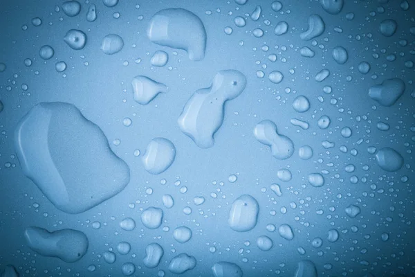 Drops of water on a color background. Toned — Stock Photo, Image