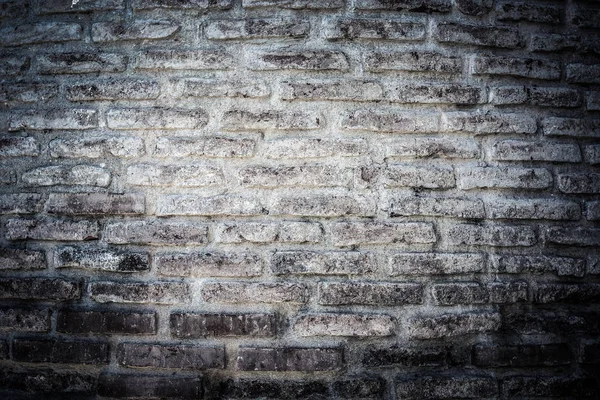 Muur van oude gebroken bakstenen. Gestructureerde achtergrond. Toned — Stockfoto