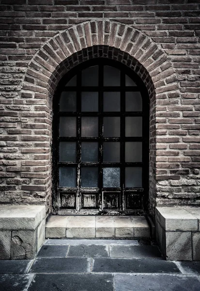 Wall of red bricks with window. Toned — Stock Photo, Image