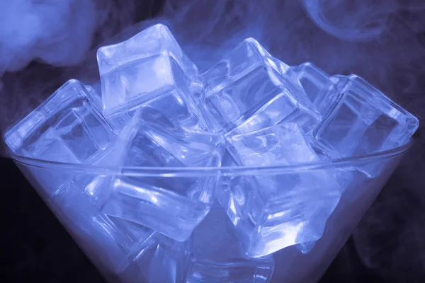 Nube de humo sobre vidrio de martini con cubitos de hielo sobre fondo negro —  Fotos de Stock