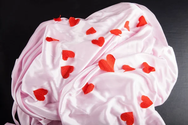 Pink silk with red paper hearts — Stock Photo, Image