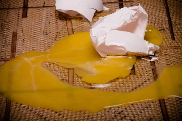 Broken eggs on the linoleum floor. Toned — Stock Photo, Image