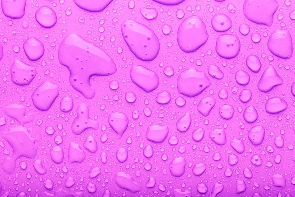 Gotas de água em um fundo a cores. Rosa. Tonificado — Fotografia de Stock