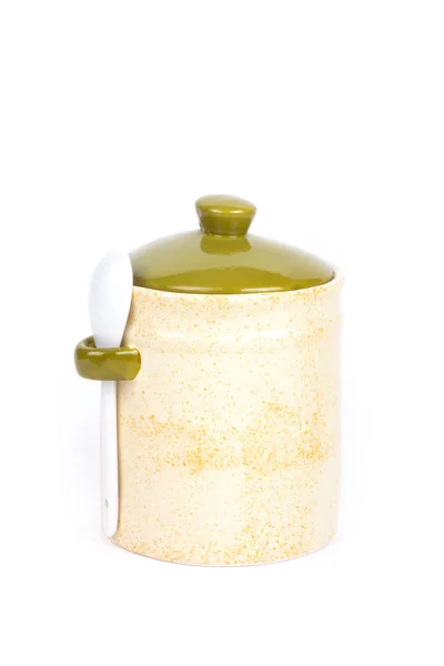 Light ceramic jar with spoon and cover on a white background — Stock Photo, Image