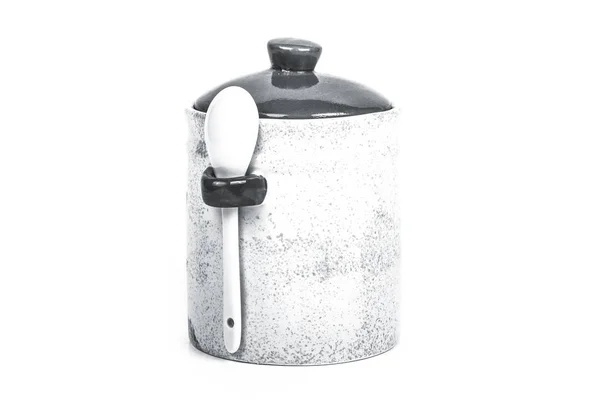 Light ceramic jar with spoon and cover on a white background. To — Stock Photo, Image